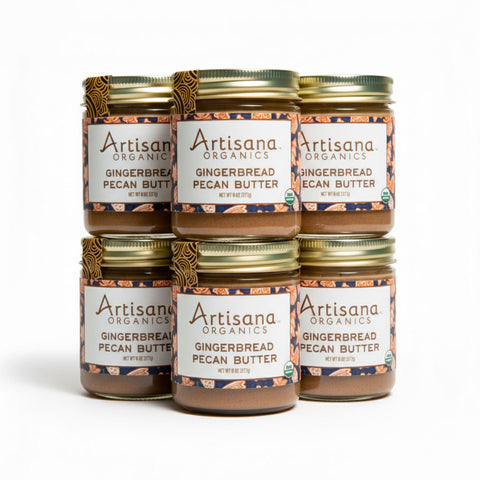 Jars of Artisana Gingerbread Pecan Butter stacked on a white background