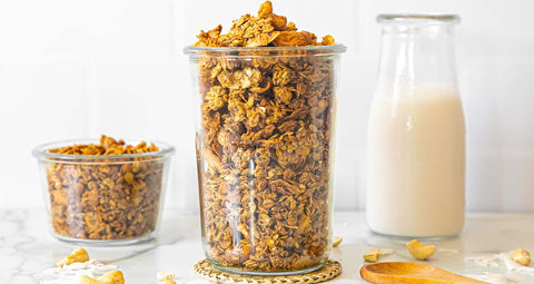 Coconut Cashini Granola with a carafe of nut mylk.