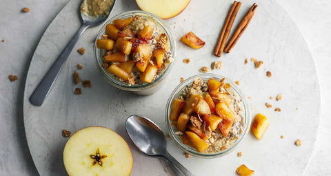 Apple pie oats in served in two cups with spoons