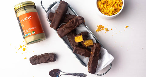 Turmeric butterfingers with a jar of Artisana Cashew Butter