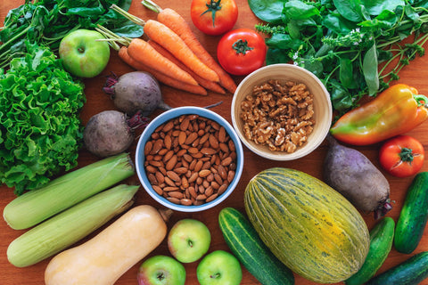 Fresh vegetables and nuts on a table.