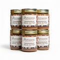 Jars of Artisana Gingerbread Pecan Butter stacked on a white background