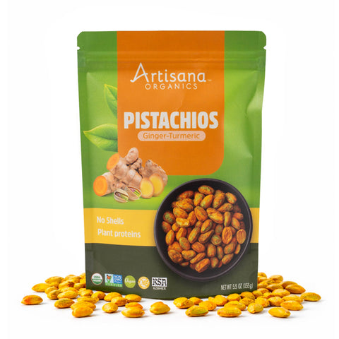 Artisana Organics Ginger Turmeric Pistachios pouch on white background with pistachios surrounding.