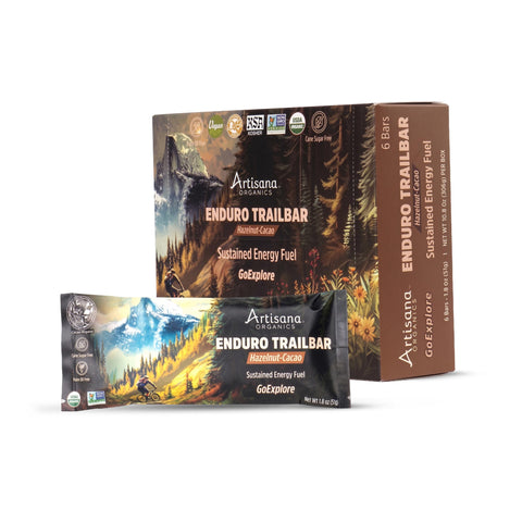 Artisana Organics Enduro Trailbar hazelnut cacao bar packaging, showing a single wrapped bar in front of a larger box on a white background.