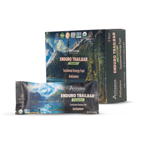 Artisana Organics Enduro Trailbar energy bars shown with a single wrapped bar in front and the product box behind on a clean white background.