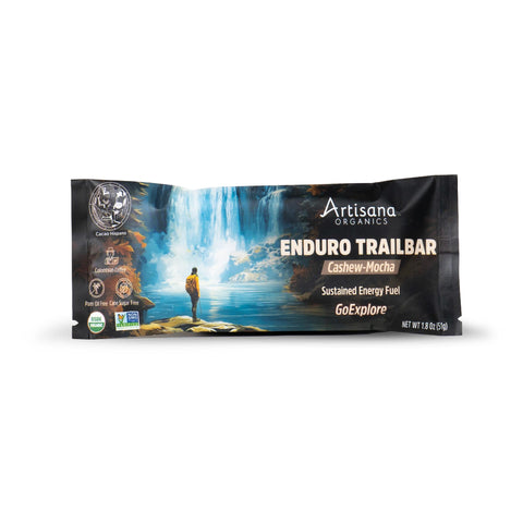 Artisana Organics Enduro Trailbar Cashew-Mocha snack bar in a 1.8 oz (51g) single-serve wrapper, featuring a scenic waterfall and mountain landscape illustration on a white background.