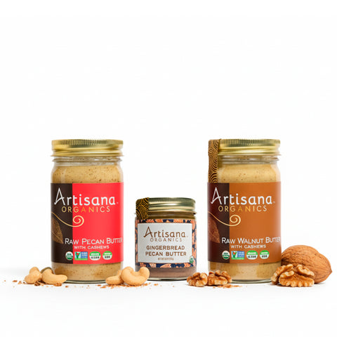 Jars of pecan, gingerbread, and walnut butters with decorative nuts surrounding them.