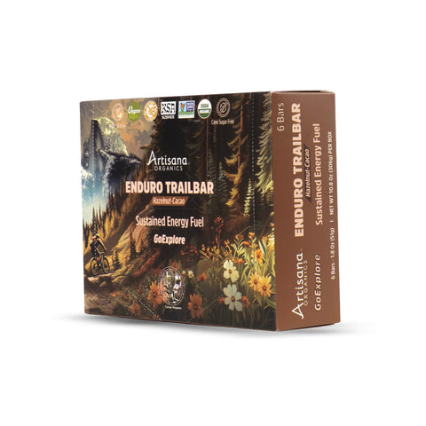 Artisana Organics Enduro Trailbar Resilience Cane Sustained Energy Fuel bar box, featuring a detailed forest and mountain illustration on the front with a brown side panel.