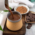 Hot chocolate poured into a mug.