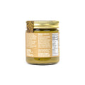 A glass jar of organic raw potatoes in oil, shown from the back with a gold lid, on a white background.
